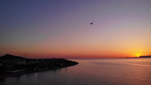 Approaching air plane to the airport during sunset on a greek island. Drone lifting shot