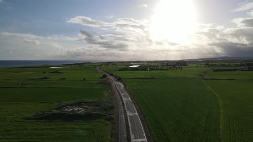 Clouds hung in the interim over the green fields
