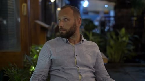 Impatient Man Waiting For Someone In Cafe And Checking Phone