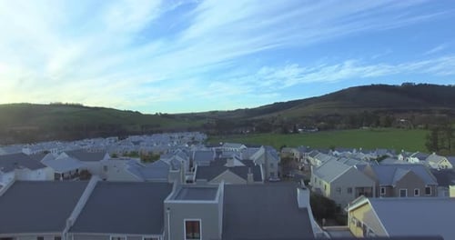 Property, houses in countryside with mountain and drone, community in nature for agriculture