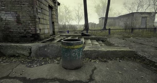 Abandoned Area with a Rusty Trash Can Next to Decaying Buildings