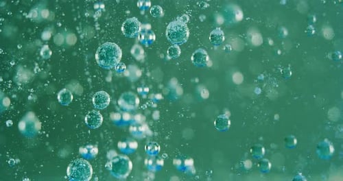 Slow motion macro of micro particles molecules in a liquid are analyzed with microscope for resear