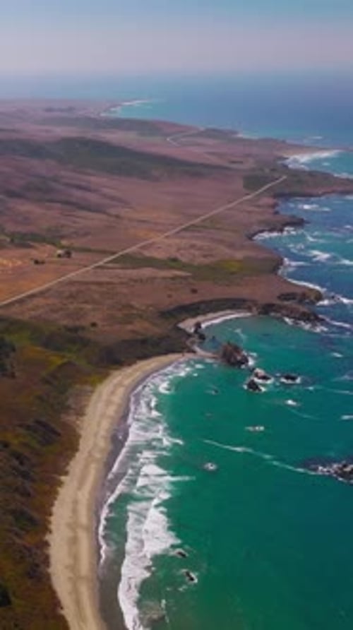 Flight over the mountainous shore of the Pacific ocean in California, USA.