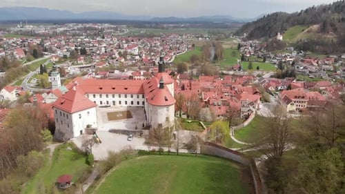 A historic medieval castle in Slovenia, a popular tourist attraction and old town in the background.