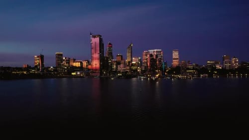 Illuminated Metropolis Silhouetted by Glittering Waters