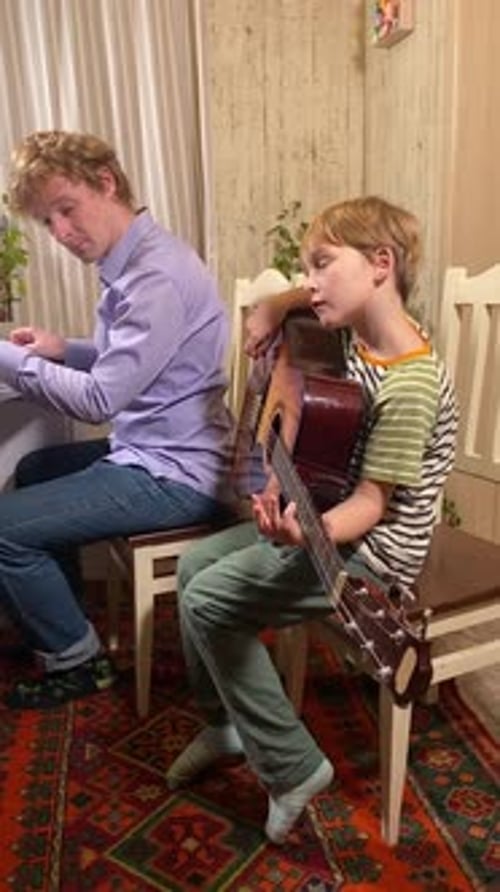 Child Sings with Guitar and Adult Plays Keyboard