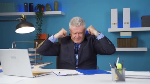 Excited Businessman Celebrates Success in Office Setting