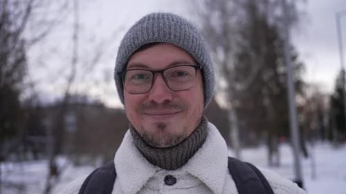 Smiling Man Close-Up Wearing Knit Cap in Winter