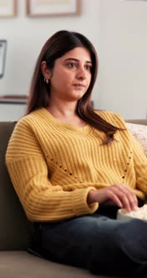 Watching tv, popcorn and search with woman on sofa for relax, channel surfing and streaming service