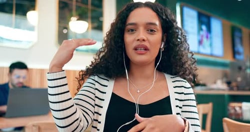 Online meeting, woman in coffee shop with earphones and video call, networking