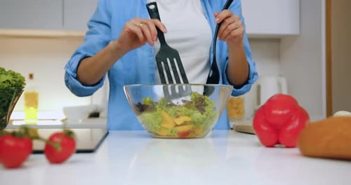 Woman Making Healthy Salad in Bright Kitchen