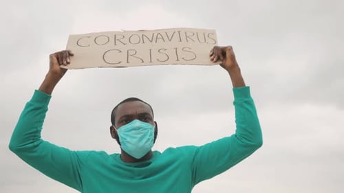 Man Protesting with Sign Wearing Face Mask