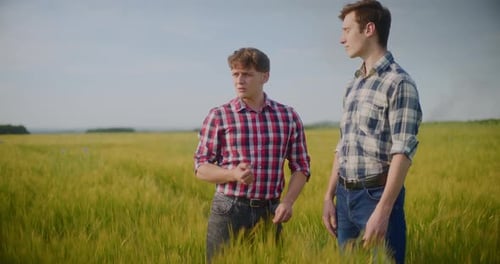 Two Male Farmers Discussing In Field Agriculture Crops Business Talking