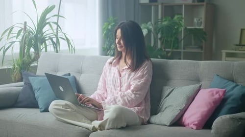 Young Adult Woman Working on Laptop at Home