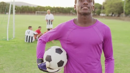 Video of african american football player on field with ball