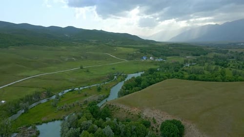Aerial view river runs through a green valley