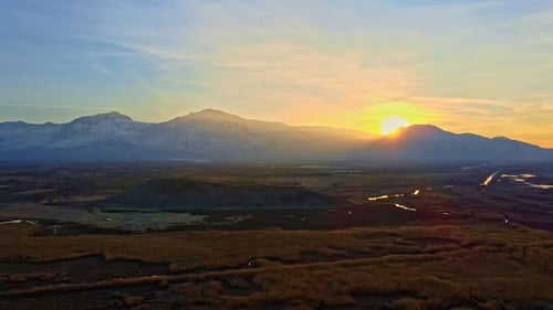 Golden Sunrise Over Majestic Snow-Capped Mountains