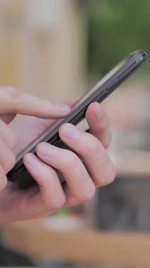 Side View of Hand Typing Message on Smartphone, Vertical Video