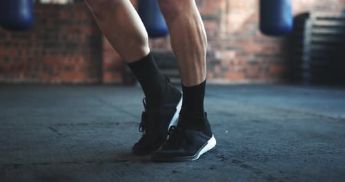 Gym, feet and fitness, man skipping for leg muscle development challenge and healthy energy