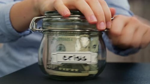 Opening Crisis Savings Jar Full of Money