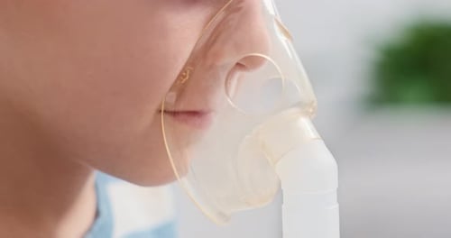 Close-Up of Person Wearing Nebulizer Mask