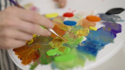 Palette with Different Colors in Hands of Professional Artist Closeup View Painter or Student of Art