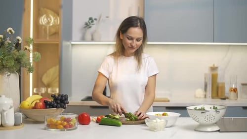 Woman Prepares Healthy Food in Modern Kitchen