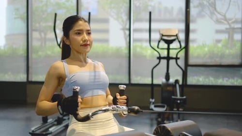 Front view of Asian women doing exercises in fitness, exercises to strengthen muscles and strength