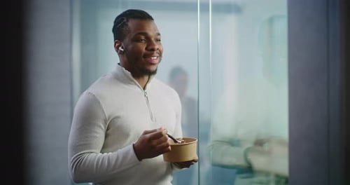 Young Adult Man Eating Lunch in Modern Office