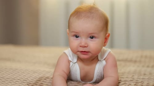 Closeup Of Baby With Curious Eyes Gentle Scene Featuring Smiling Infant With Warm Lighting Closeup