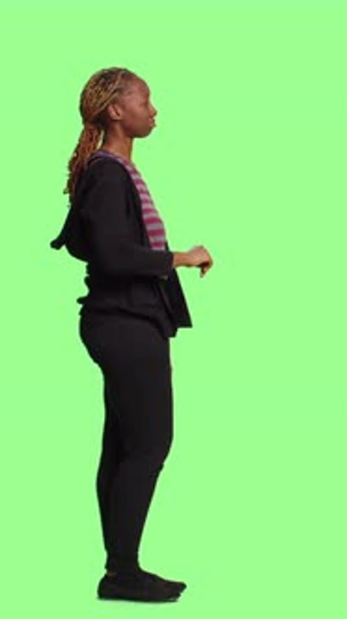 Vertical Video African American Girl Looking at 3d Hologram on Full Body Greenscreen