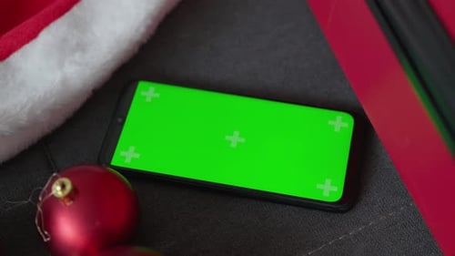 Smartphone with Green Screen and Christmas Decorations