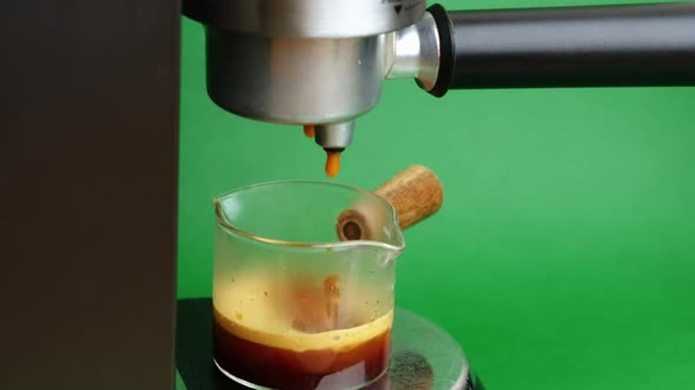 Espresso Drips into Clear Glass with Green Background, Food Stock ...