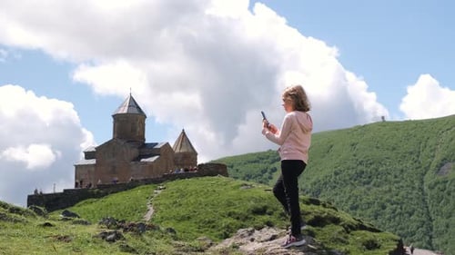 Girl Taking Photos By the Old Georgian Church