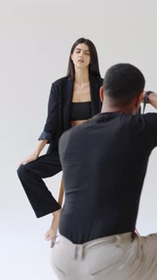 Professional Photographer Taking Pictures of Fashion Model in Studio
