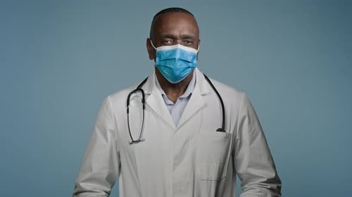 Closeup Mature Male Doctor Surgeon in Protective Mask Looks at Camera Man Experienced Hospital