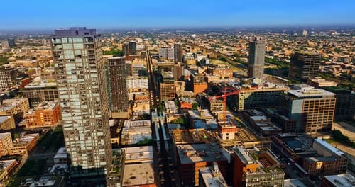 Bright sun lighting the panorama of big city. Chicago cityscape from aerial perspective.