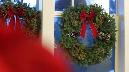 Christmas wreaths hanging in windows, winter season decoration