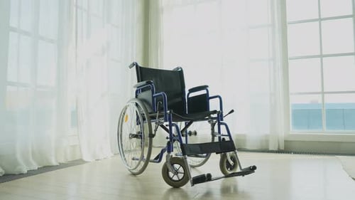Empty Wheelchair Waiting for Patient Services in Living Room Retirement Home Hospital Chair for