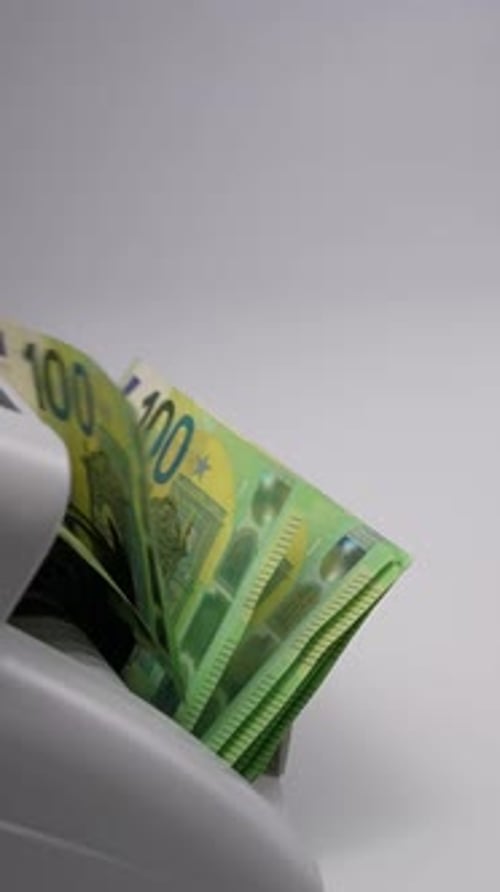 Machine Counts Stack of Green Euro Banknotes