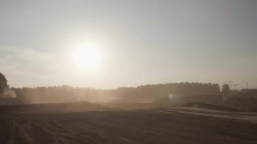 Silhouette of Biker Jumping with Motorcycle From Behind Low Hill