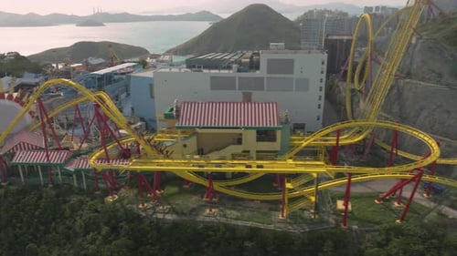 Sideways follow shot of fast moving 'Hair-Raiser' rollercoaster in Ocean Park, Hong Kong