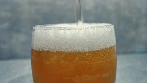 Macro Shot Of Pouring Beer Into Glass Slow Motion