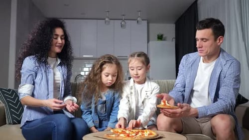 Family Enjoys Pizza Together at Home