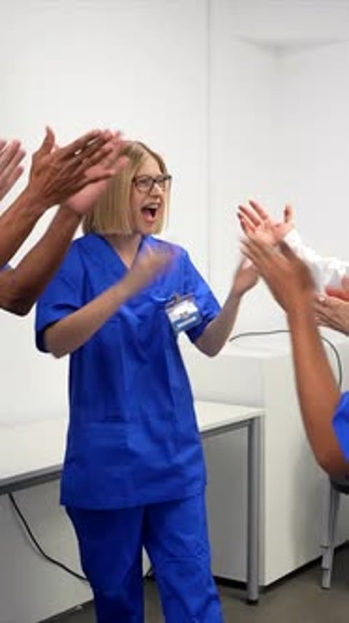 Medical team celebrating success in hospital conference room