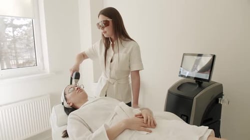 Woman Receiving Laser Facial Treatment in Clinic
