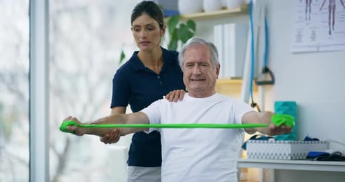 Man Exercising with Resistance Band in Physical Therapy