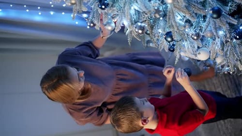 Mother and Child Decorating Christmas Tree