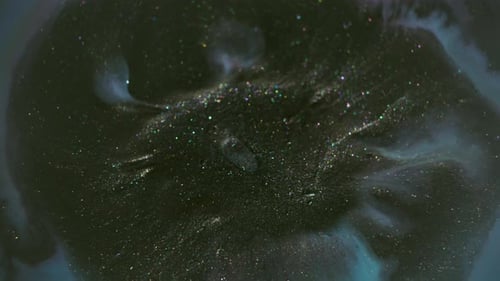 Dark Fluid with Shimmering Particles and Light Blue Wisps