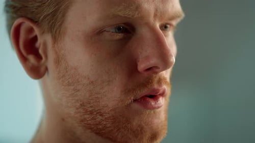 Close-up portrait of a young man with beard